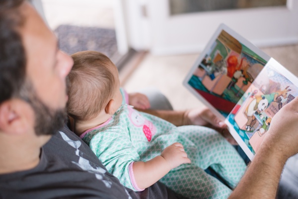 father reading to baby