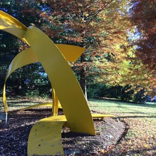 Surrounded by the changing leaves on a crisp fall day, this bright yellow modern sculpture blends seamlessly into its outdoor surroundings at Strathmore.