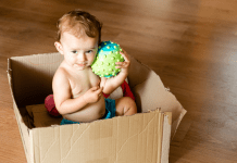 baby sitting in a moving box